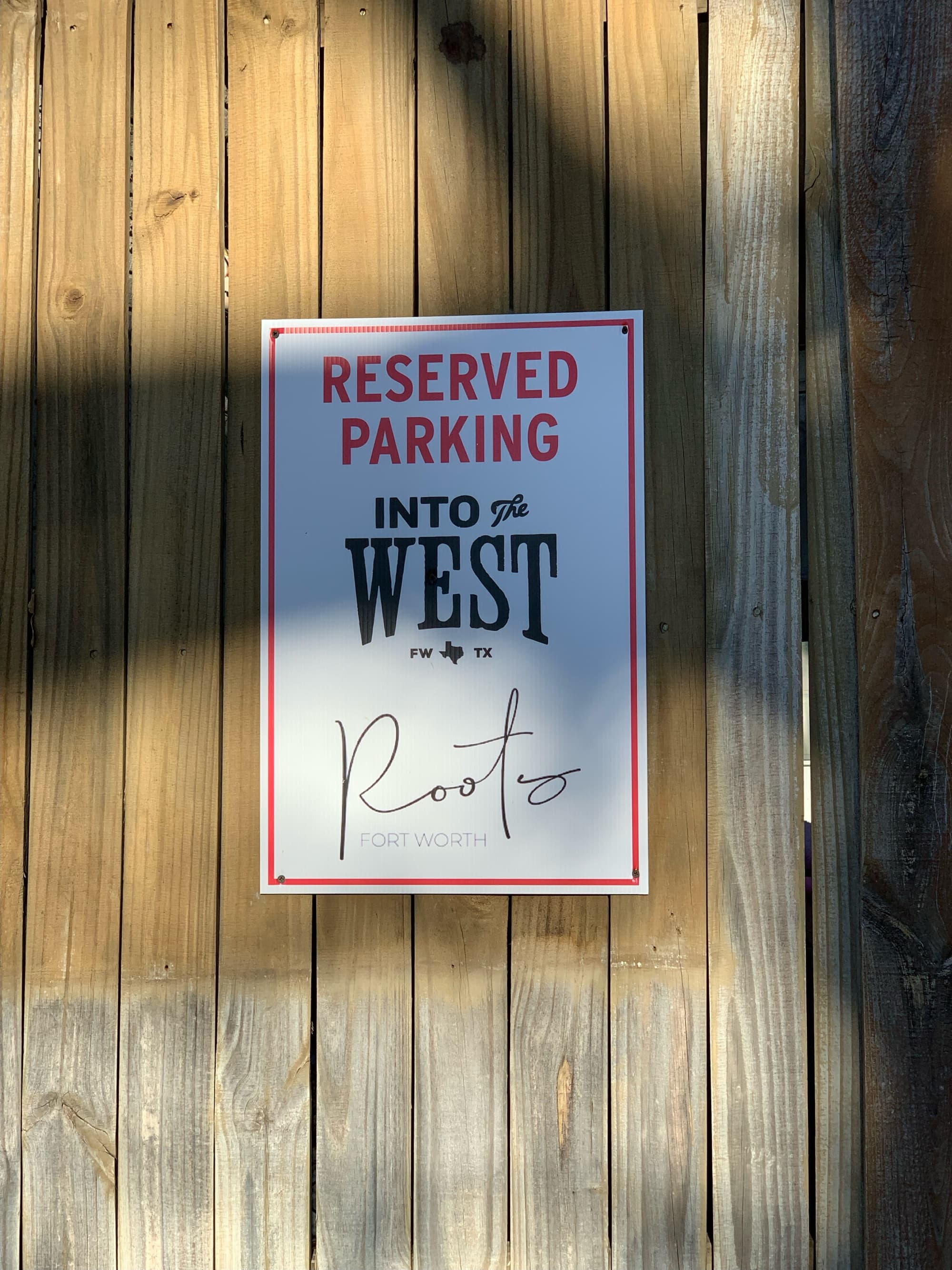 A parking sign from Roots Fort Worth